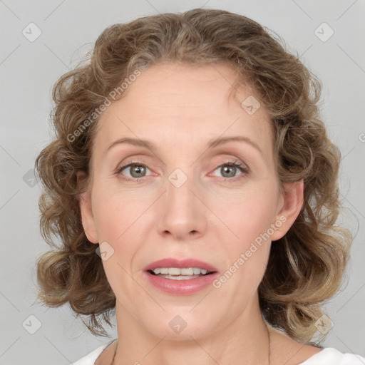 Joyful white adult female with medium  brown hair and blue eyes