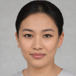 Joyful asian young-adult female with short  brown hair and brown eyes