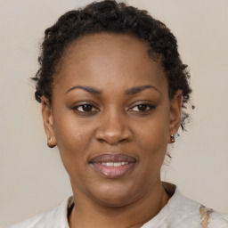 Joyful black adult female with short  brown hair and brown eyes