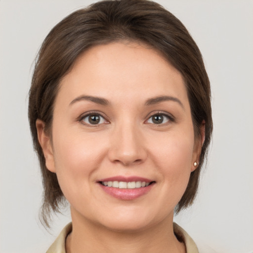 Joyful white young-adult female with medium  brown hair and brown eyes