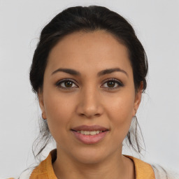 Joyful latino young-adult female with medium  brown hair and brown eyes