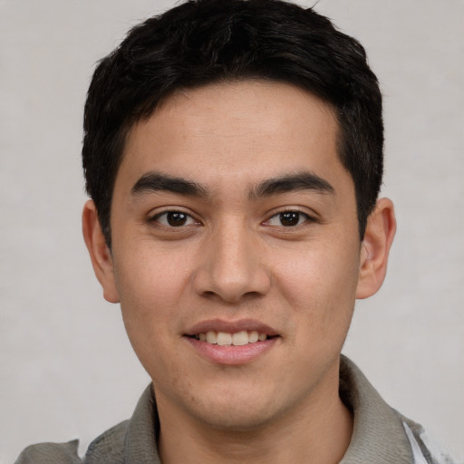 Joyful white young-adult male with short  black hair and brown eyes