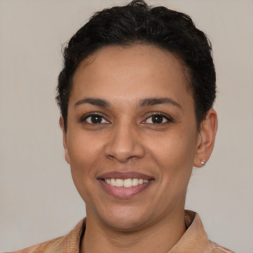 Joyful latino young-adult female with short  brown hair and brown eyes