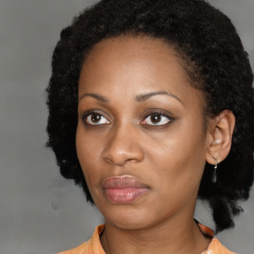 Joyful black young-adult female with medium  black hair and brown eyes