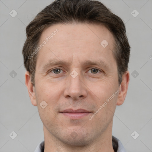 Joyful white adult male with short  brown hair and grey eyes