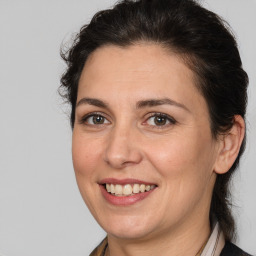 Joyful white adult female with medium  brown hair and brown eyes