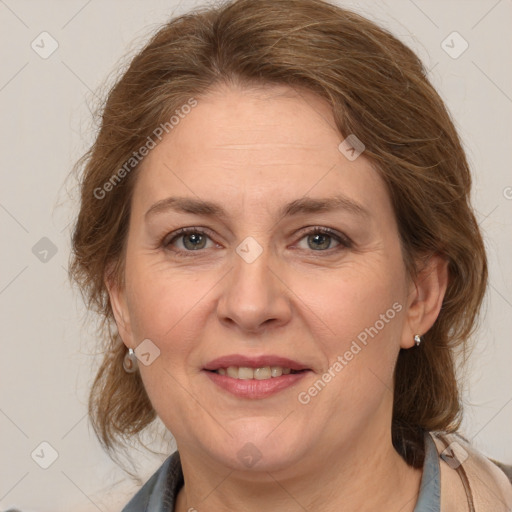 Joyful white adult female with medium  brown hair and grey eyes