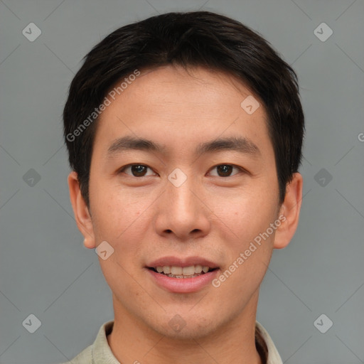 Joyful asian young-adult male with short  brown hair and brown eyes