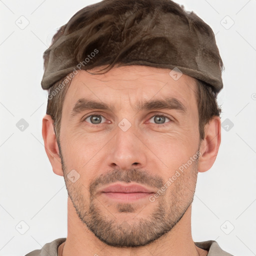 Joyful white adult male with short  brown hair and grey eyes