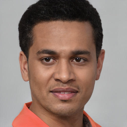 Joyful latino young-adult male with short  brown hair and brown eyes