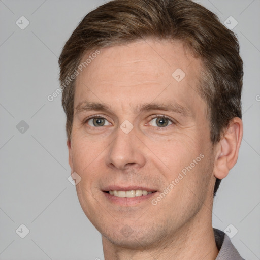 Joyful white adult male with short  brown hair and brown eyes