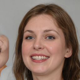 Joyful white young-adult female with medium  brown hair and blue eyes