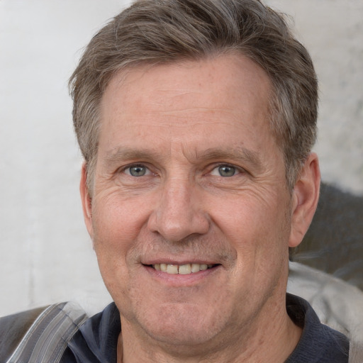 Joyful white middle-aged male with short  brown hair and grey eyes