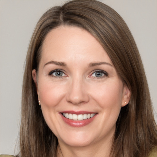 Joyful white adult female with long  brown hair and brown eyes