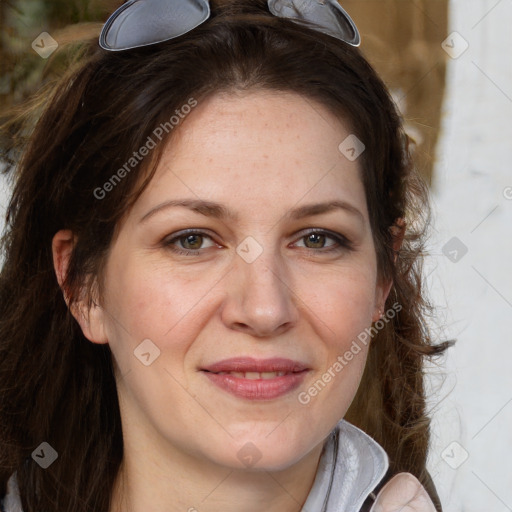 Joyful white adult female with long  brown hair and grey eyes