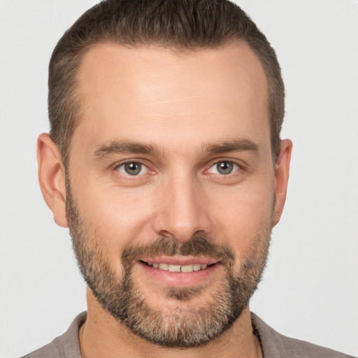 Joyful white young-adult male with short  brown hair and brown eyes