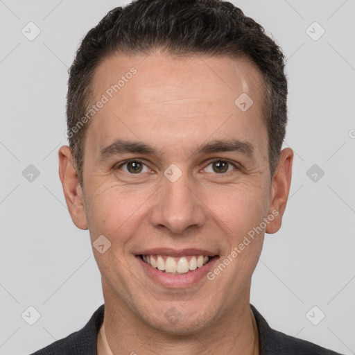 Joyful white adult male with short  brown hair and brown eyes