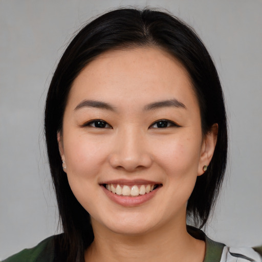 Joyful white young-adult female with medium  black hair and brown eyes
