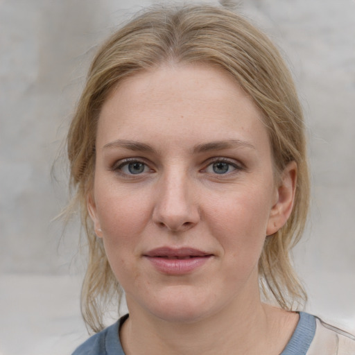 Joyful white young-adult female with medium  brown hair and blue eyes