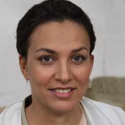 Joyful white adult female with short  brown hair and brown eyes