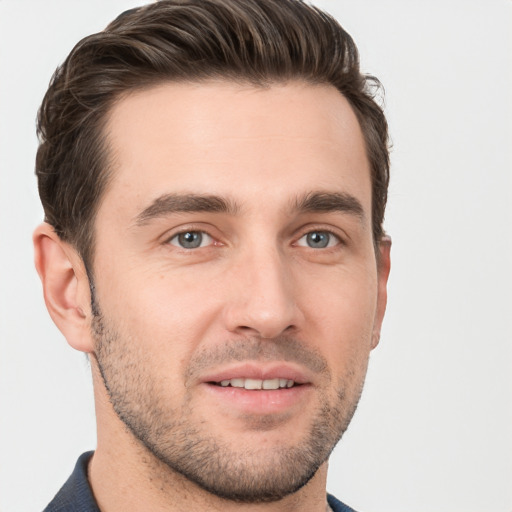 Joyful white young-adult male with short  brown hair and grey eyes