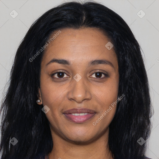 Joyful black young-adult female with long  black hair and brown eyes