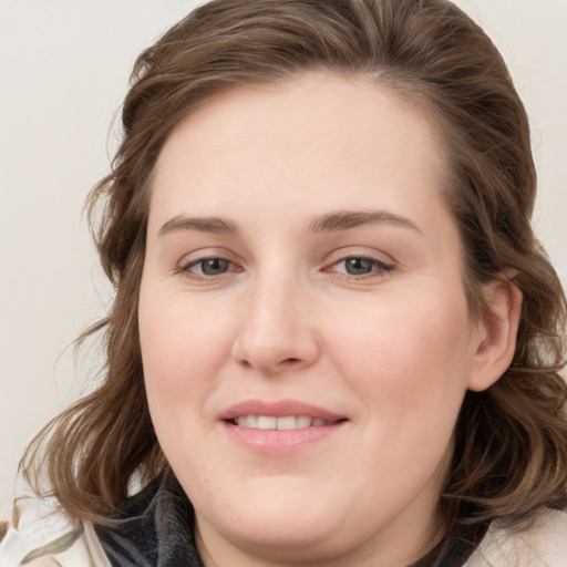 Joyful white young-adult female with medium  brown hair and blue eyes