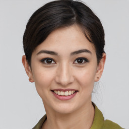 Joyful asian young-adult female with short  brown hair and brown eyes