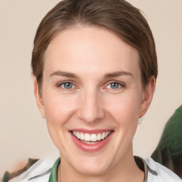 Joyful white young-adult female with medium  brown hair and green eyes