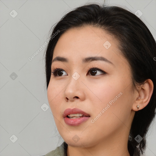 Joyful asian young-adult female with medium  brown hair and brown eyes