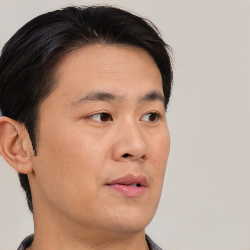 Neutral asian young-adult male with short  brown hair and brown eyes