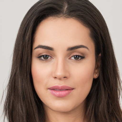 Joyful white young-adult female with long  brown hair and brown eyes