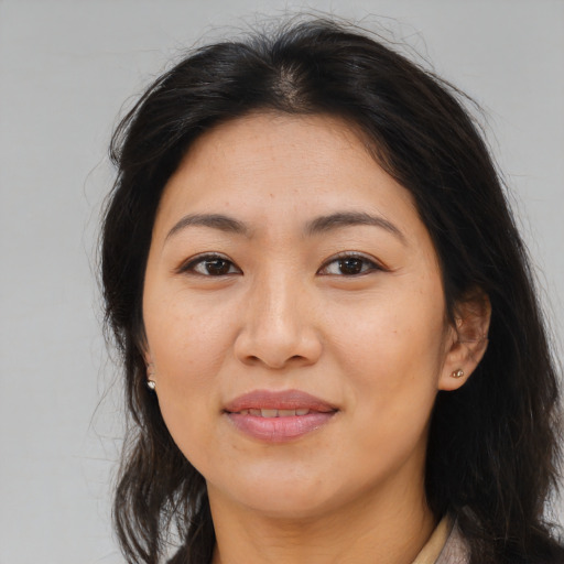 Joyful asian adult female with long  brown hair and brown eyes