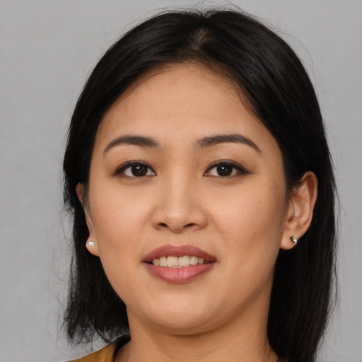 Joyful asian young-adult female with long  black hair and brown eyes