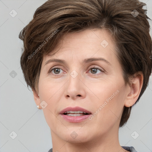 Joyful white adult female with short  brown hair and brown eyes