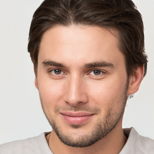 Joyful white young-adult male with short  brown hair and brown eyes