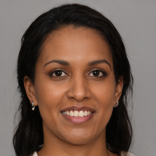 Joyful black young-adult female with medium  brown hair and brown eyes