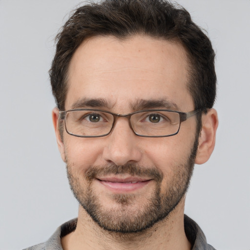 Joyful white adult male with short  brown hair and brown eyes