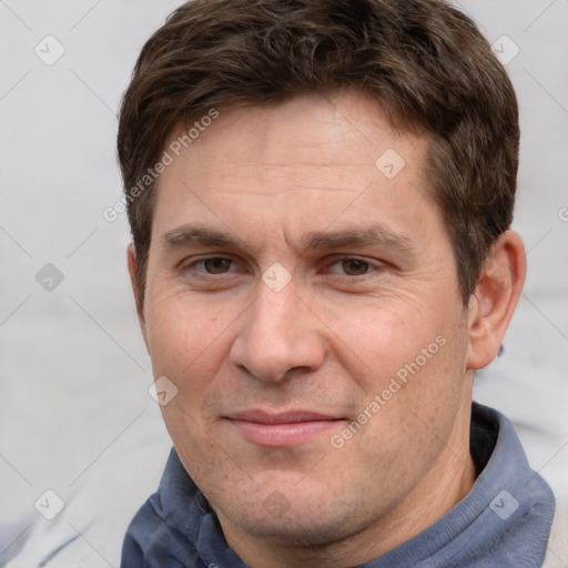 Joyful white adult male with short  brown hair and grey eyes