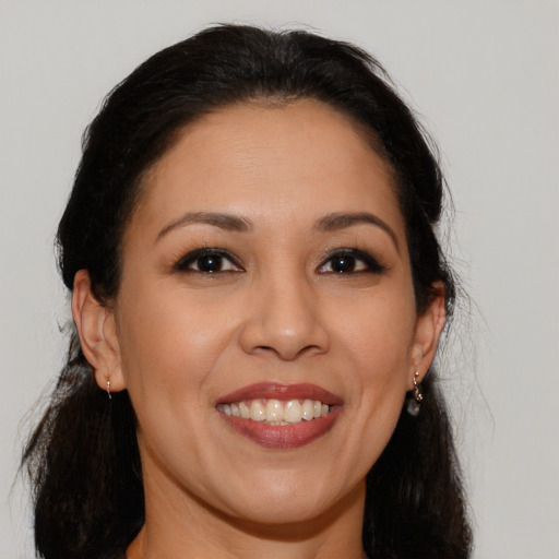 Joyful latino young-adult female with long  brown hair and brown eyes