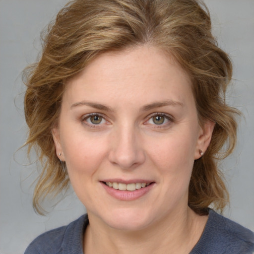 Joyful white young-adult female with medium  brown hair and blue eyes