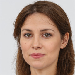 Joyful white adult female with long  brown hair and brown eyes