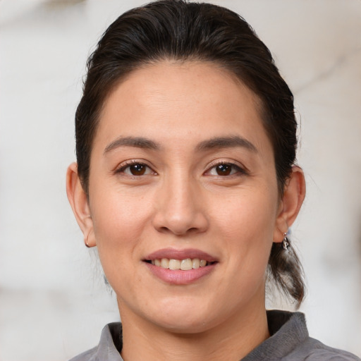 Joyful white young-adult female with medium  brown hair and brown eyes