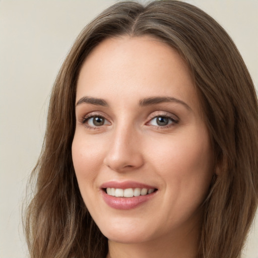 Joyful white young-adult female with long  brown hair and green eyes