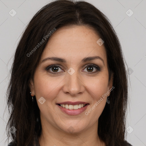 Joyful white adult female with long  brown hair and brown eyes