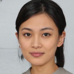 Joyful asian young-adult female with medium  black hair and brown eyes