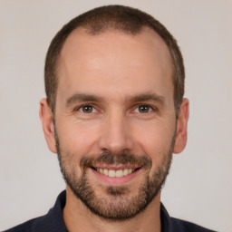 Joyful white adult male with short  brown hair and brown eyes