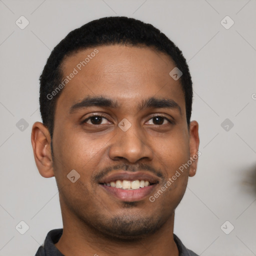 Joyful black young-adult male with short  black hair and brown eyes