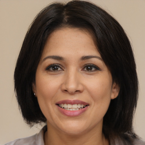 Joyful white adult female with medium  brown hair and brown eyes