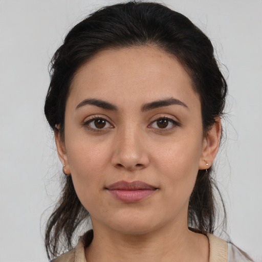 Joyful latino young-adult female with medium  brown hair and brown eyes